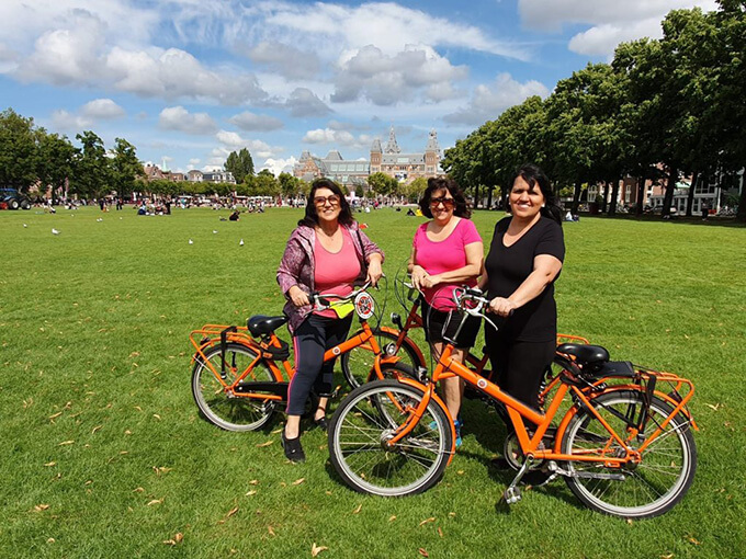 Imagem de grupo de mulheres no Museumplein fazendo a passeio em Amsterdam de bike com guia brasileiro