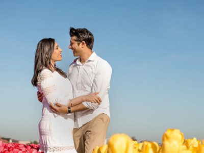 Imagem de casal passeando e tirando fotos nos campos de tulipas